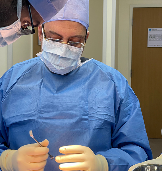 Dr. Mohamed Mashhour surrounded by medical instruments and equipment.