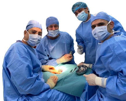 Dr. Mohamed Mashhour's team wearing blue scrubs and masks work diligently in an operating room